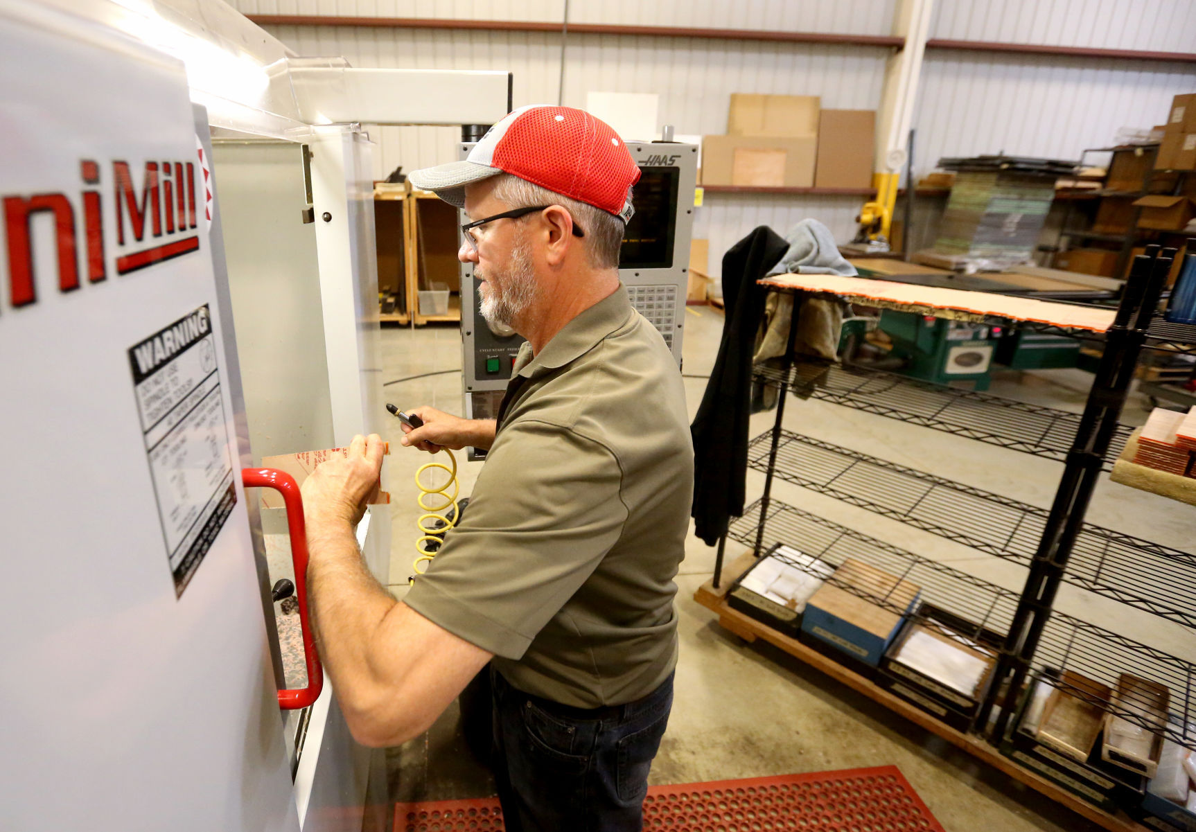 Dan Ehlinger processes an acrylic shelf at IBI Scientific in Peosta, Iowa. PHOTO CREDIT: JESSICA REILLY