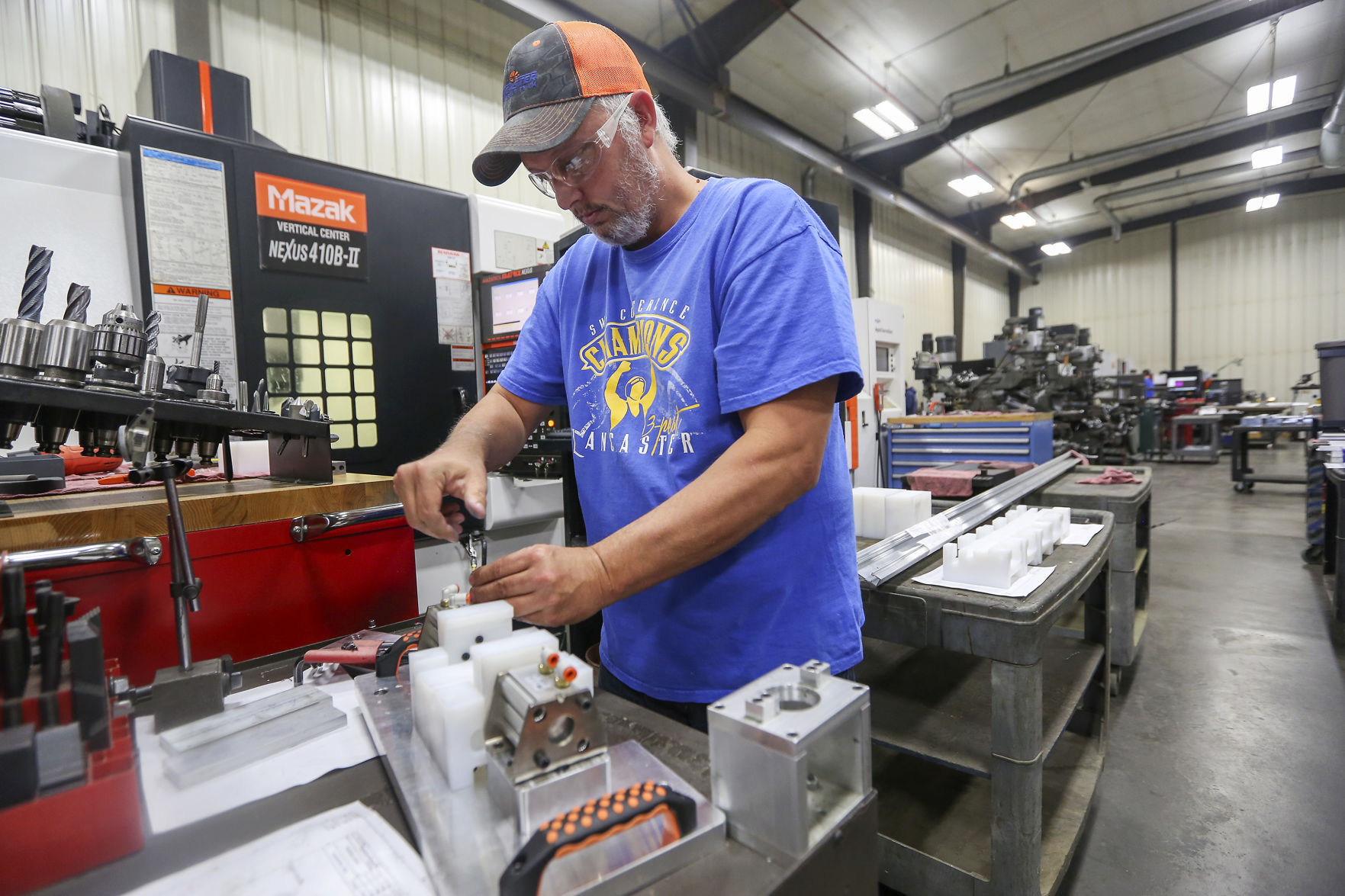 Tony Gundlach assembles a component for a custom CNC machine at Lancaster Machine & Tool on Thursday, Oct. 26, 2017, in Lancaster, Wis.    PHOTO CREDIT: NICKI KOHL