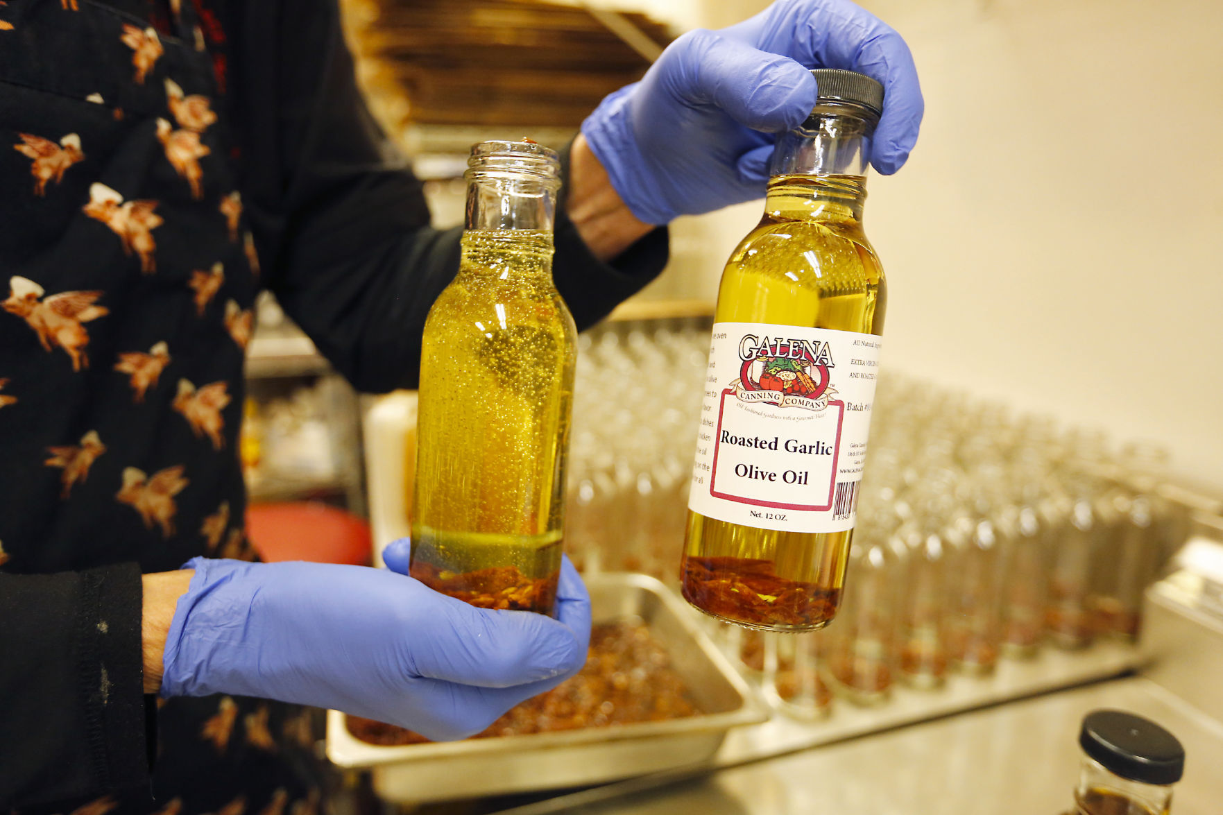Chef Ivo Puidak shows his roasted garlic olive oil at Galena Canning Company in Galena, Ill.    PHOTO CREDIT: EILEEN MESLAR