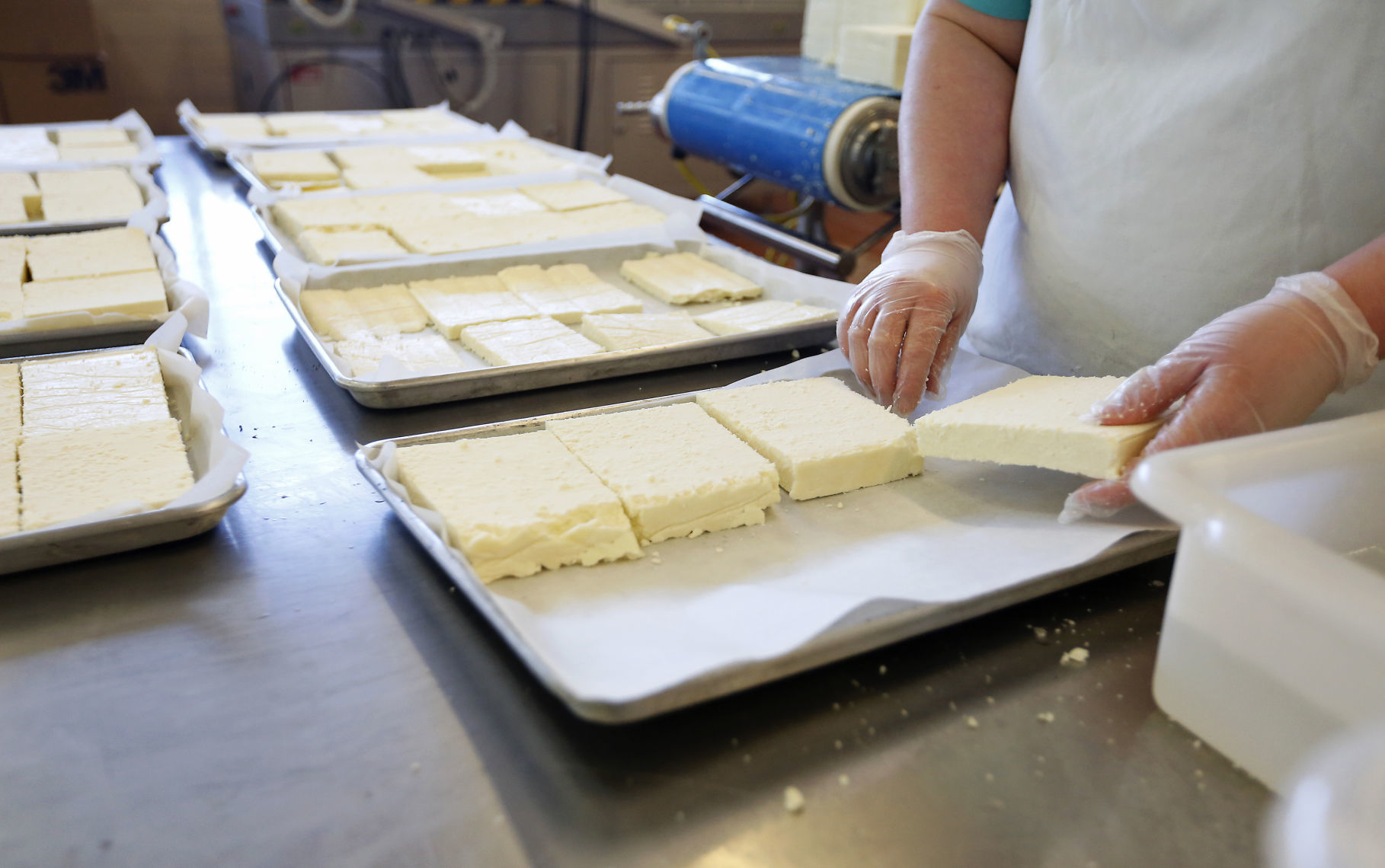 Amanda Collins, of Mount Hope, Wis., prepares cheese to be put in the oven at Carr Valley Cheese Company in Fennimore, Wis., on Thursday, Mar. 22, 2018.    PHOTO CREDIT: EILEEN MESLAR