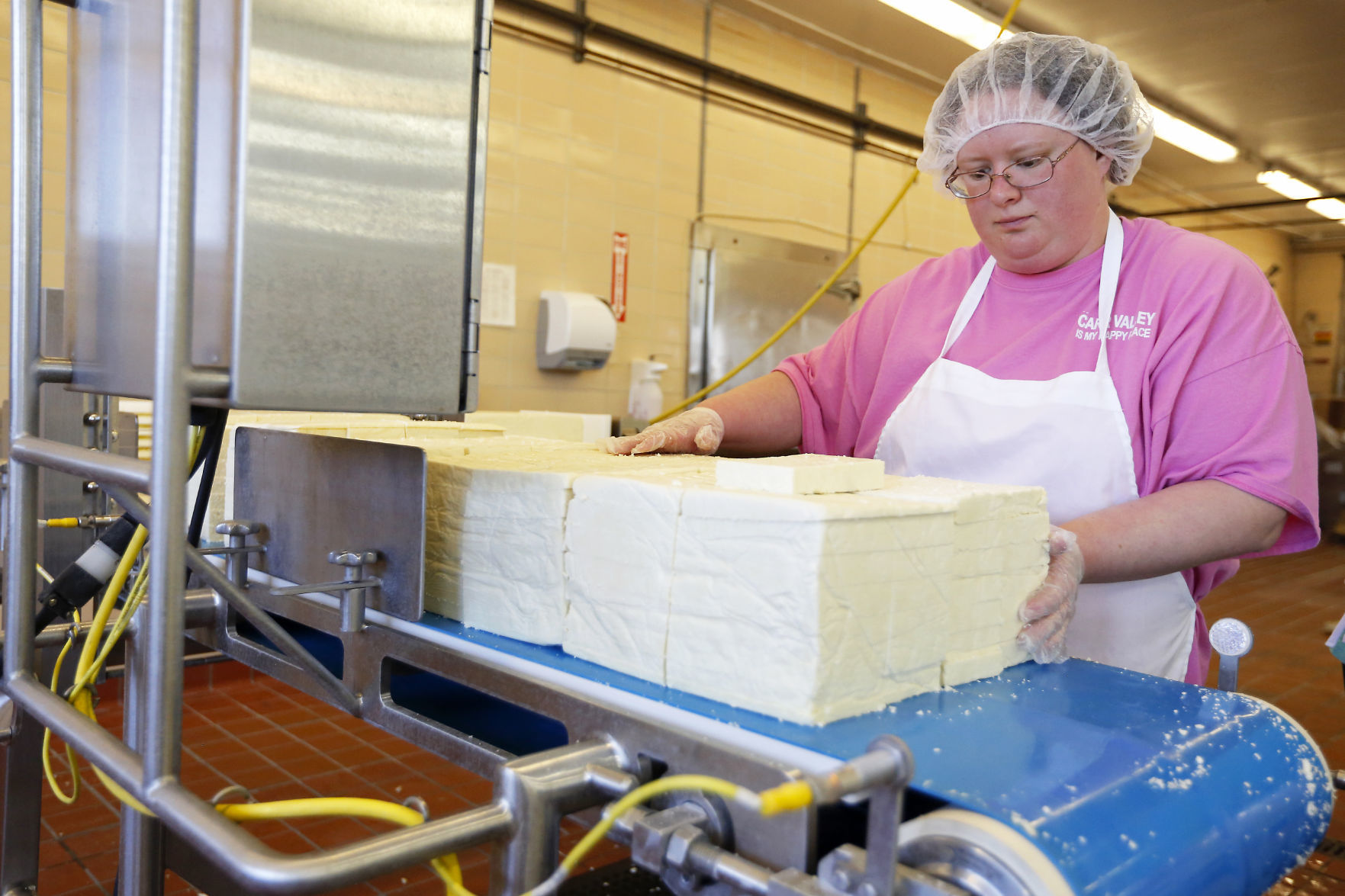 Renee Collins, of Mount Hope, Wis., stacks cheese to be put on trays at Carr Valley Cheese Company in Fennimore, Wis., on Thursday, Mar. 22, 2018.    PHOTO CREDIT: EILEEN MESLAR