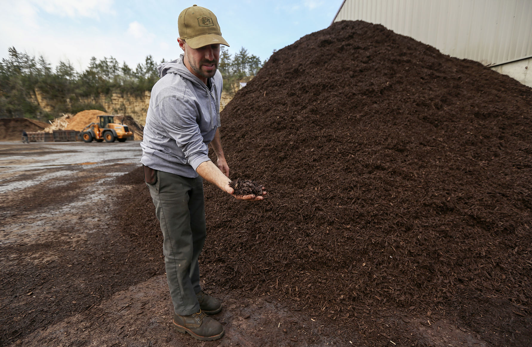 Operations manager Tom Miller shows colored mulch at Dubuque Mulch Company in Dubuque on Friday, May 4, 2018.    PHOTO CREDIT: NICKI KOHL