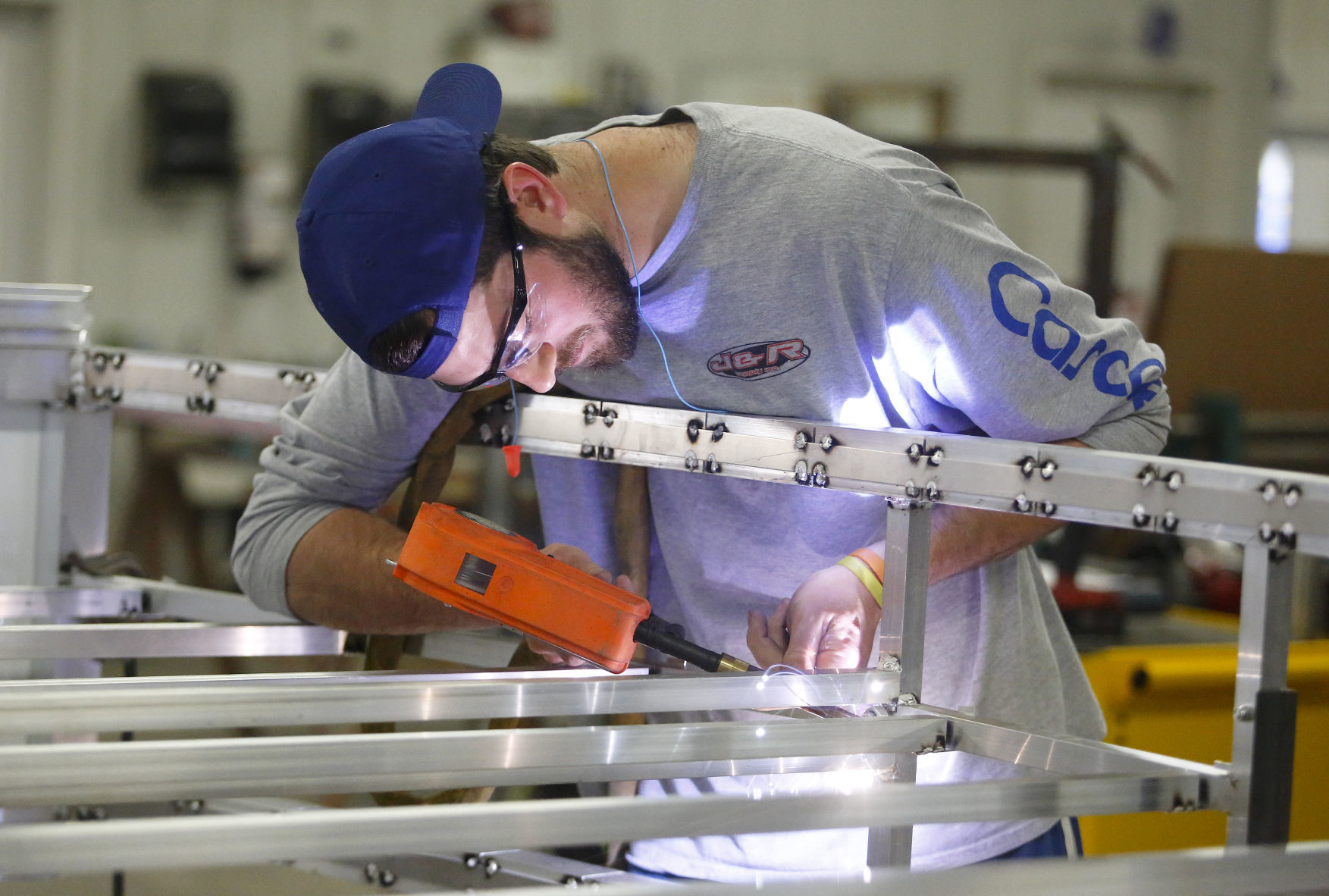 Garret Lange welds aluminum tubing. The business also installs the signs it manufactures.    PHOTO CREDIT: EILEEN MESLAR