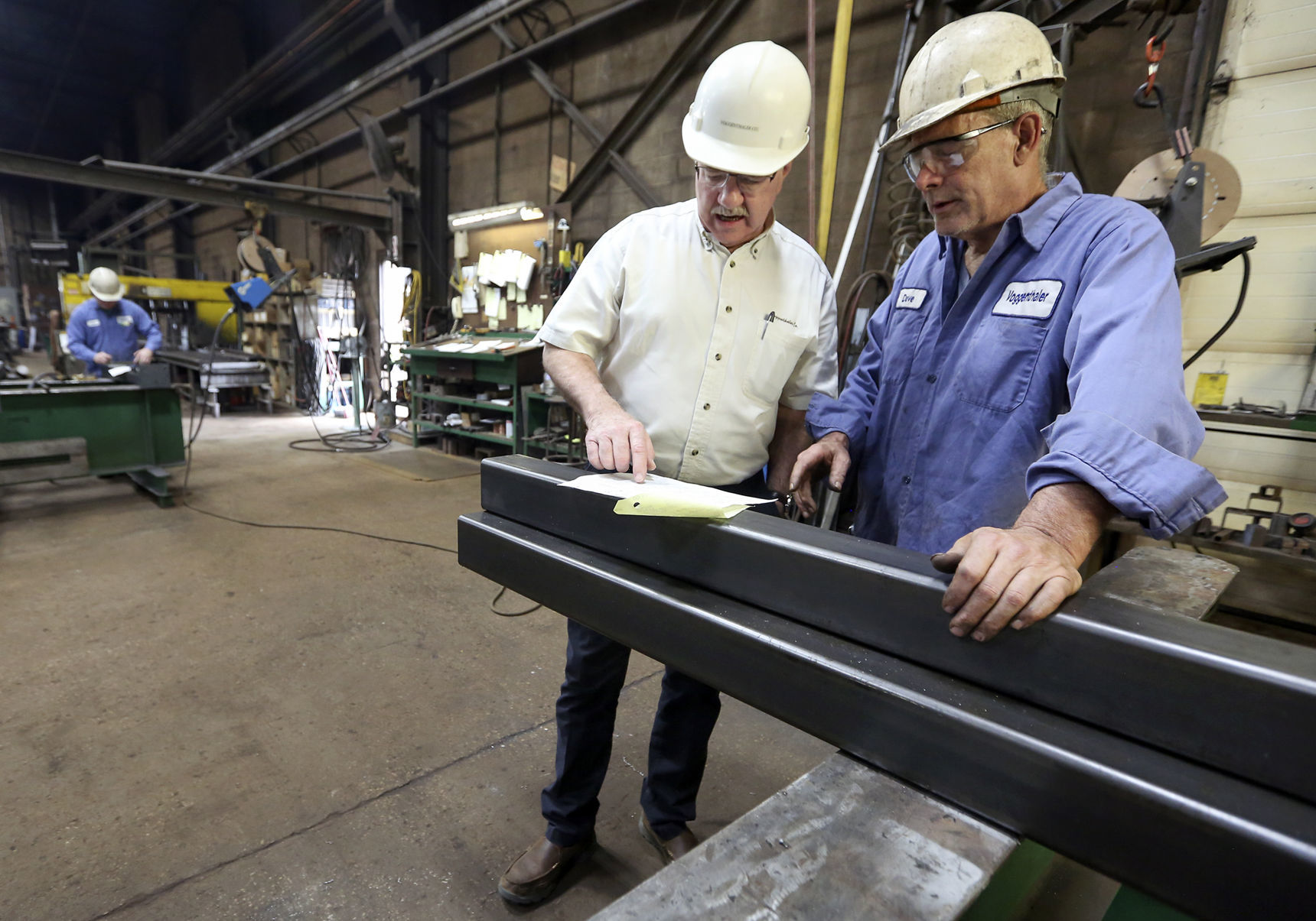 Kevin Kisting (left) and Dave Walsh discuss miter cuts on tube bracing at E.J. Voggenthaler Co. in Dubuque on Wednesday, June 27, 2018.    PHOTO CREDIT: NICKI KOHL