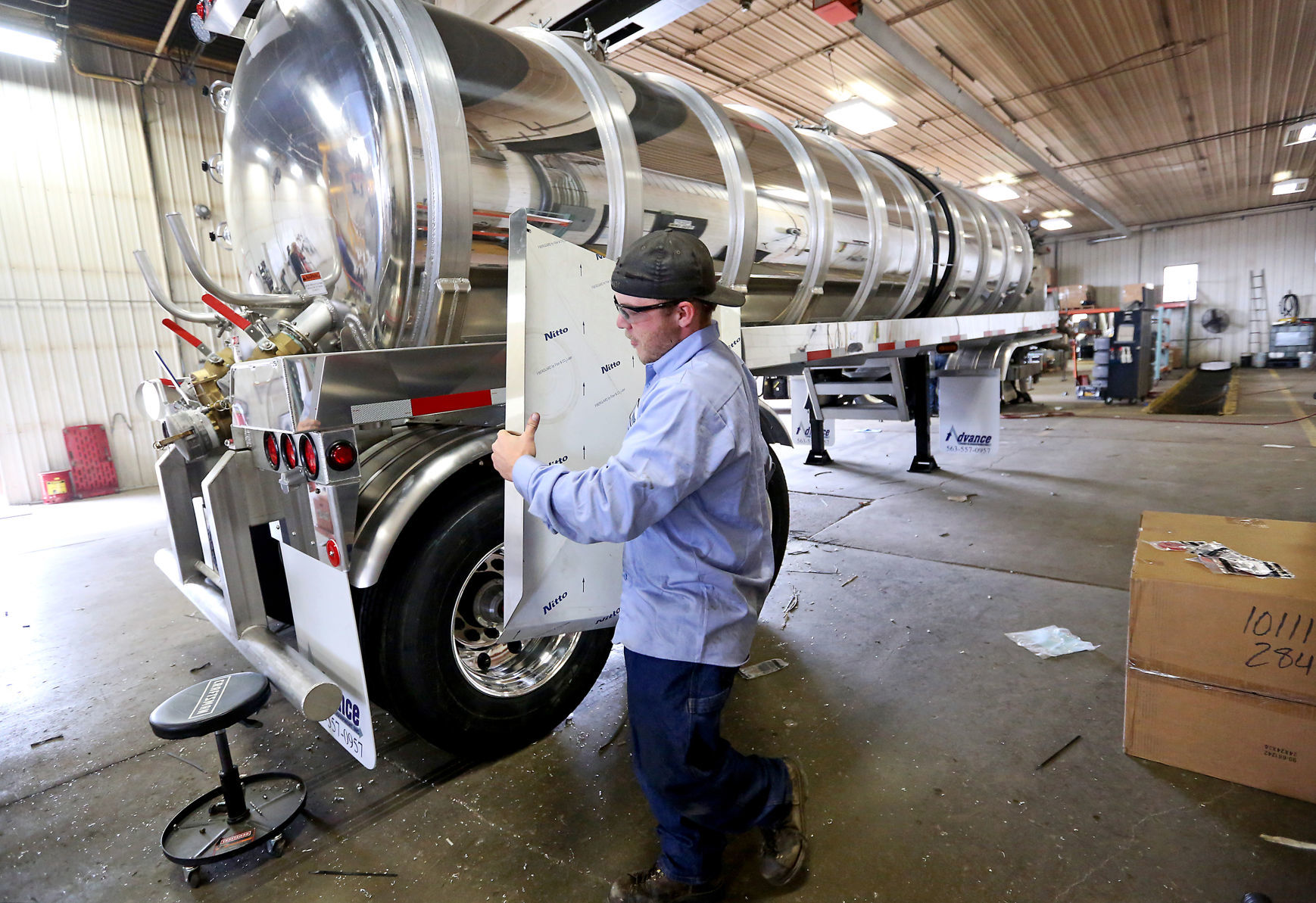 Travis O’Mara installs a spill pan on a 6,000-pound aluminum tanker trailer. The business started with two workers, and now employs 34.    PHOTO CREDIT: Jessica Reilly
