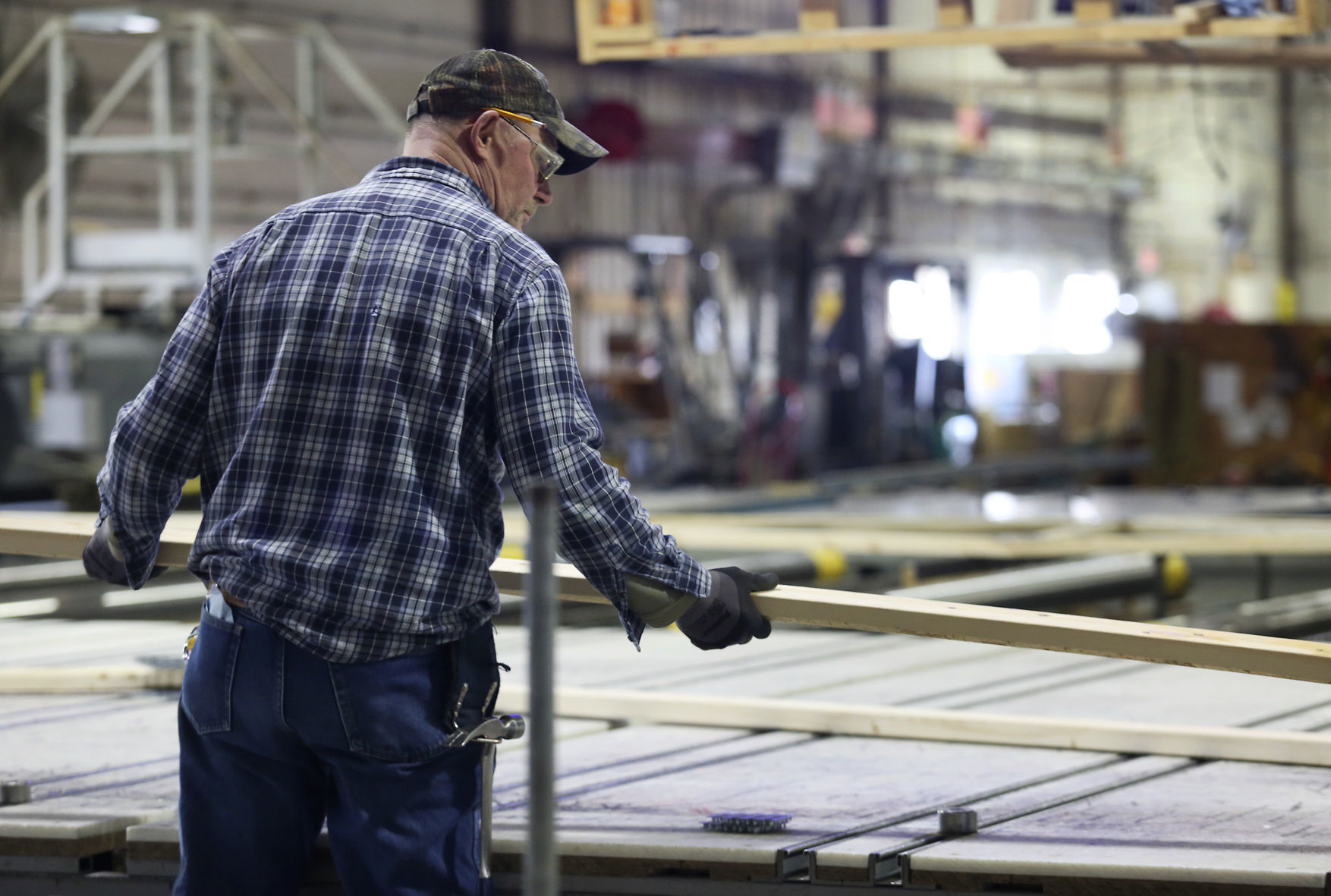 Mark Bruns works to assemble a wood truss at Cascade Manufacturing in Cascade, Iowa, on Thursday, Feb. 19, 2019.    PHOTO CREDIT: NICKI KOHL