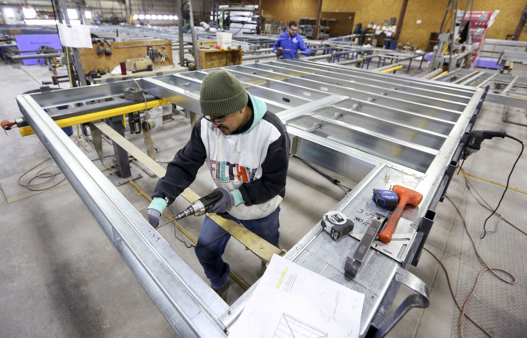 Javier Montoya assembles steel wall panels at Cascade Manufacturing Co. The Iowa company’s specialty is trusses for a building’s roof or flooring. It sends its products throughout the United States. The family-owned company began in 1953, and today has 250 employees across all its sites.    PHOTO CREDIT: NICKI KOHL