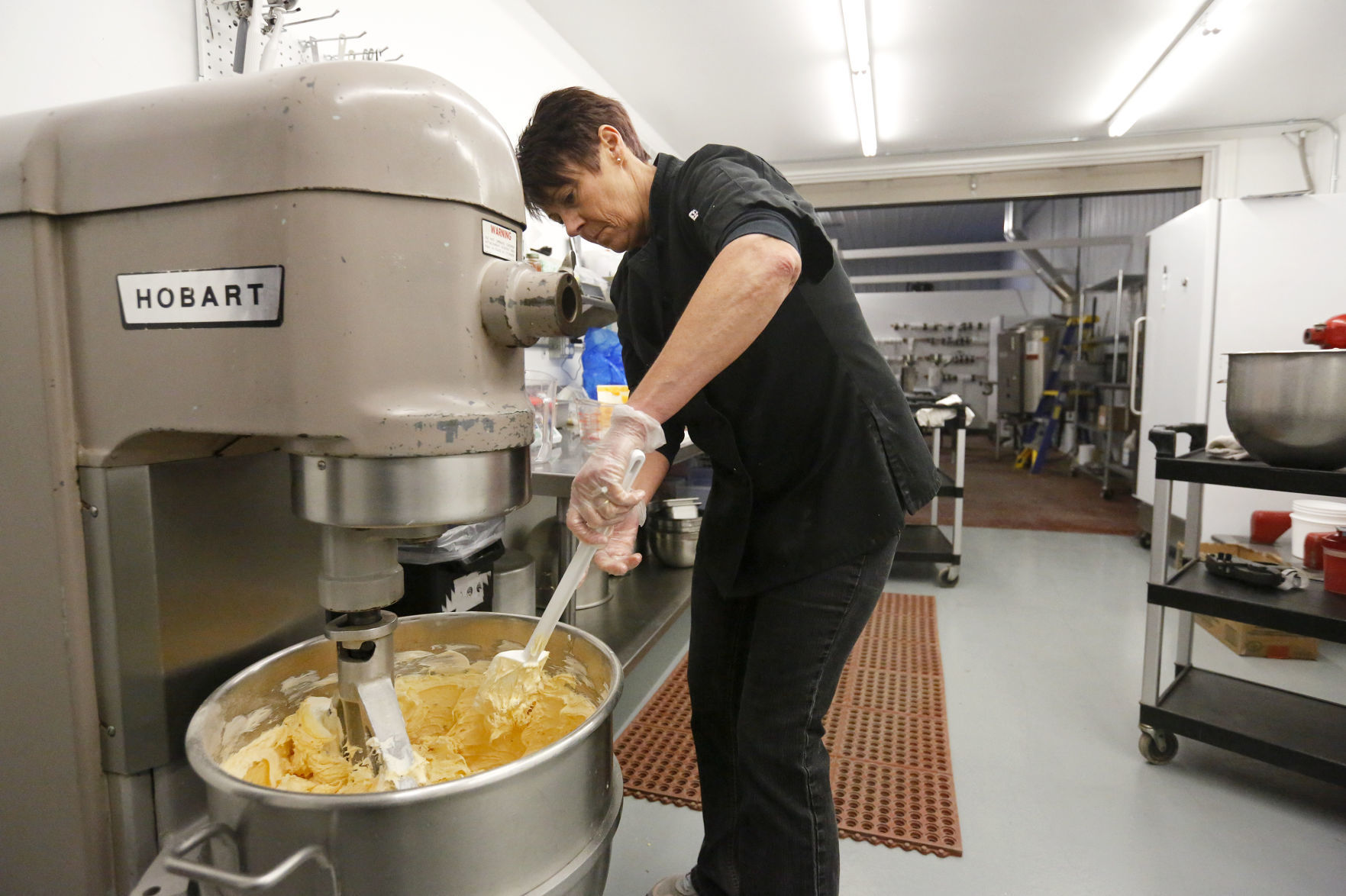 Warehouse manager Rita Connolly mixes Cheddar Bacon dip at Simply Parker’s. The Bellevue, Iowa, business started in 2016. It makes dips, sauces and cheeses with its unique recipes. The products of Simply Parker’s also are in several tri-state grocery stores and breweries.    PHOTO CREDIT: EILEEN MESLAR