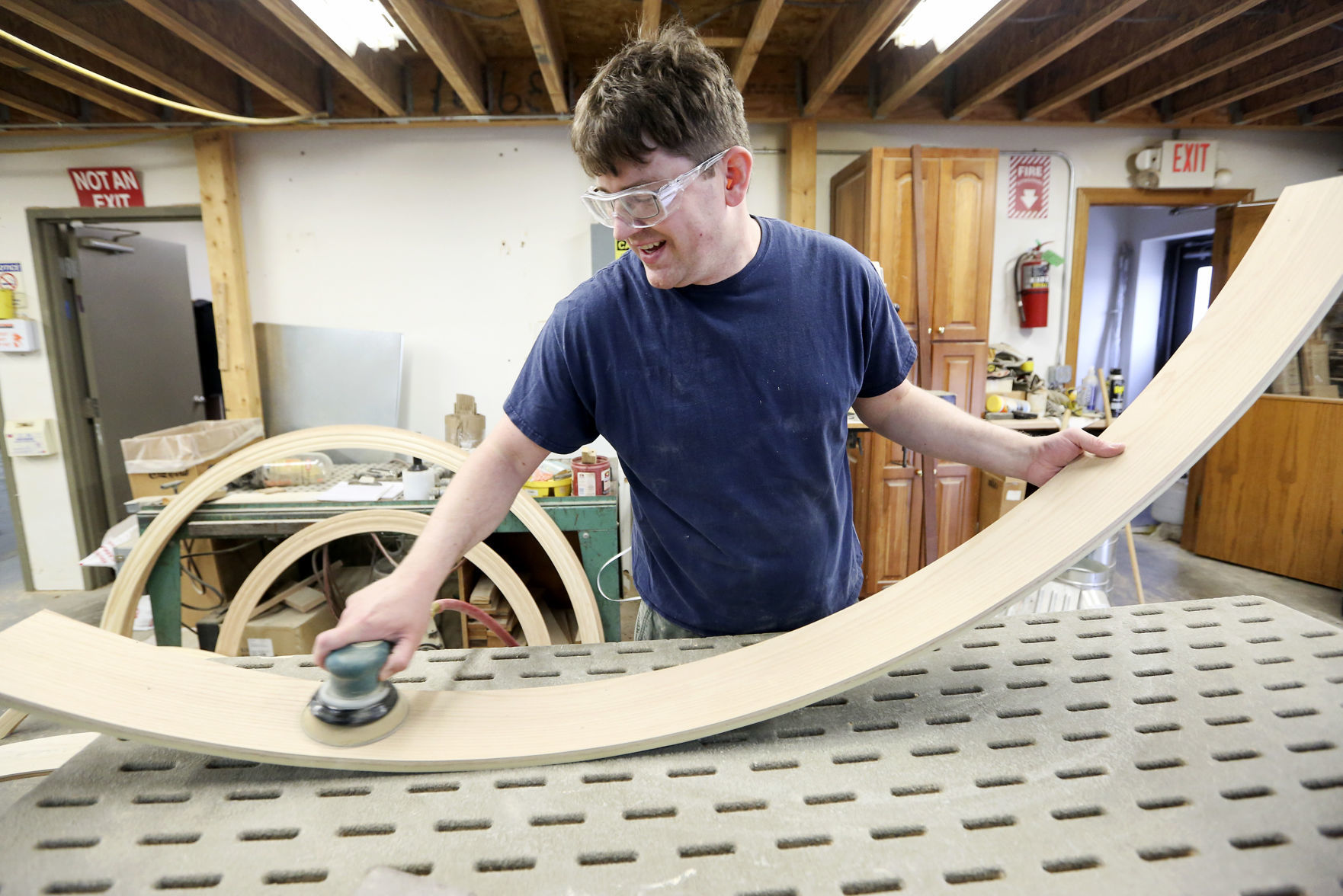 Brian Kramer sands a jamb at Heritage Wood Products. The Worthington, Iowa, manufacturer creates curved wood pieces for trim, molding and window casings. The business, which formerly operated in New Vienna, got its start in 2001.    PHOTO CREDIT: NICKI KOHL