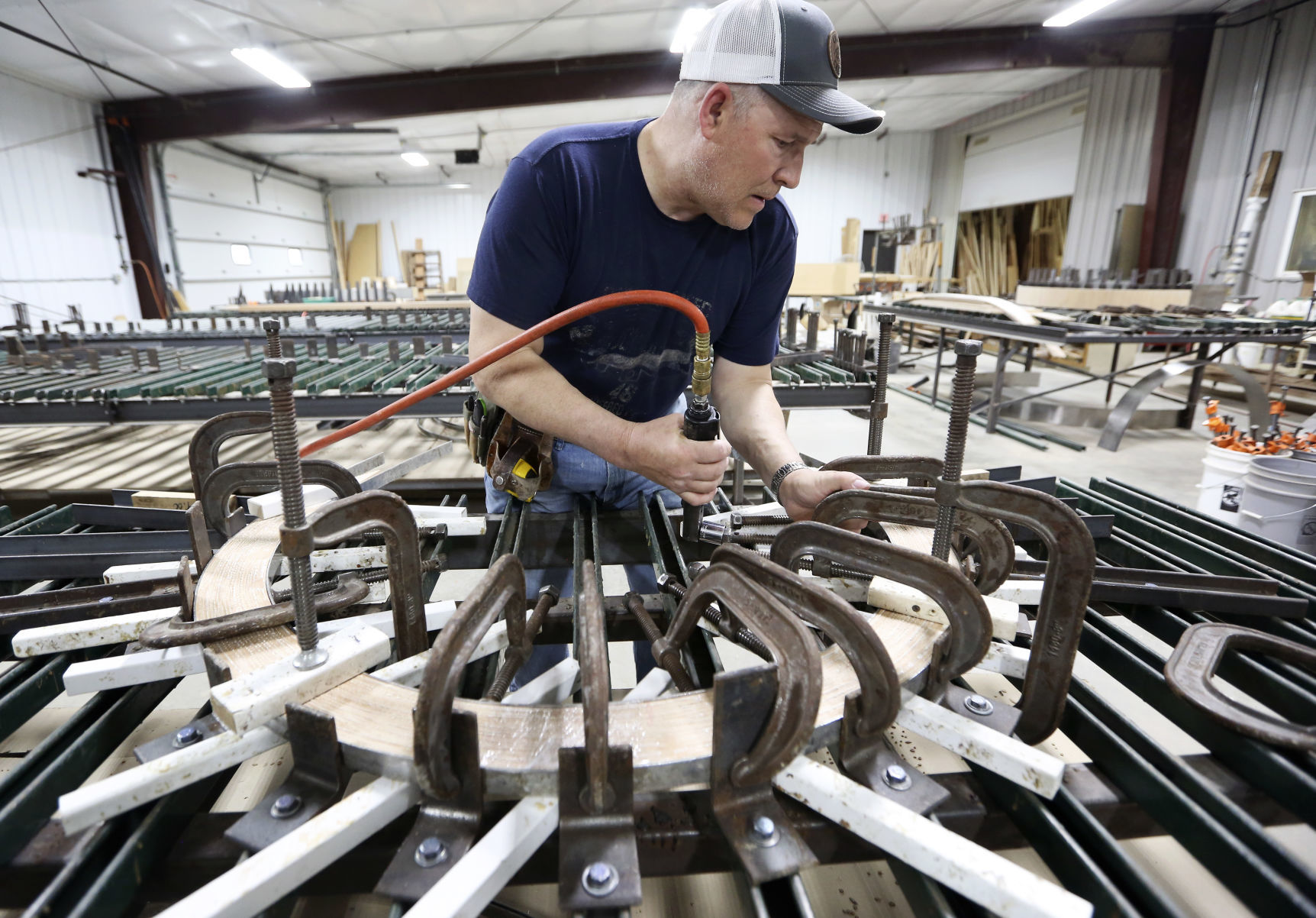 Dave Faust works to form a piece of wood at Heritage Wood Products in Worthington, Iowa, on Thursday, May 16, 2019.    PHOTO CREDIT: NICKI KOHL