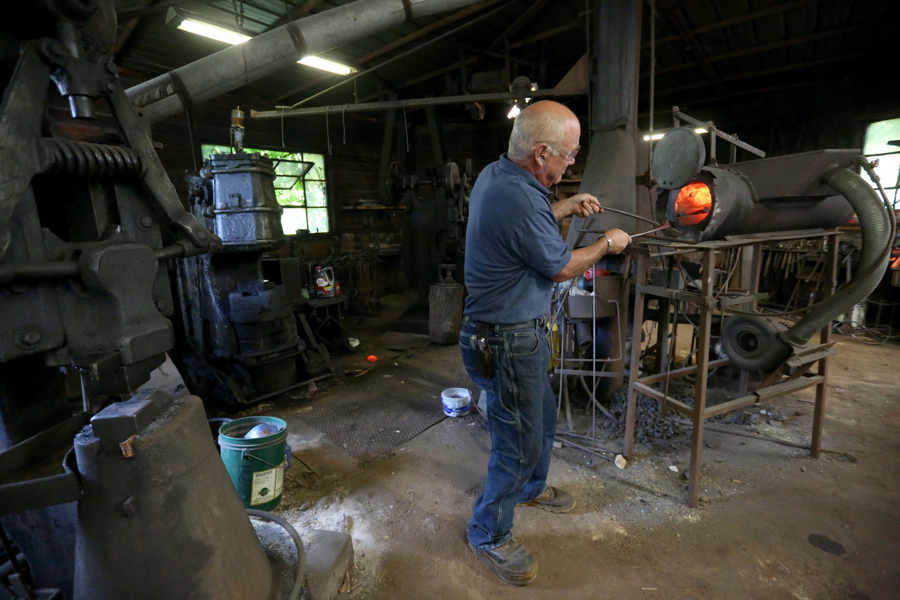 Ted Schuster works with a piece of hot metal at Prairie Forge in Hopkinton, Iowa, on Monday, July 22, 2019.    PHOTO CREDIT: JESSICA REILLY