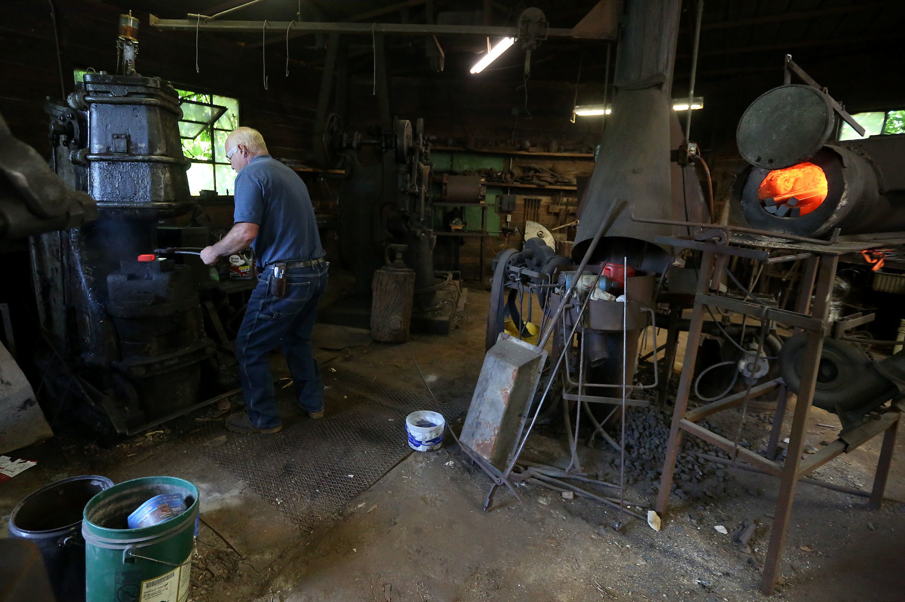 Ted Schuster works with a piece of hot metal at Prairie Forge in Hopkinton, Iowa, on Monday, July 22, 2019.    PHOTO CREDIT: JESSICA REILLY