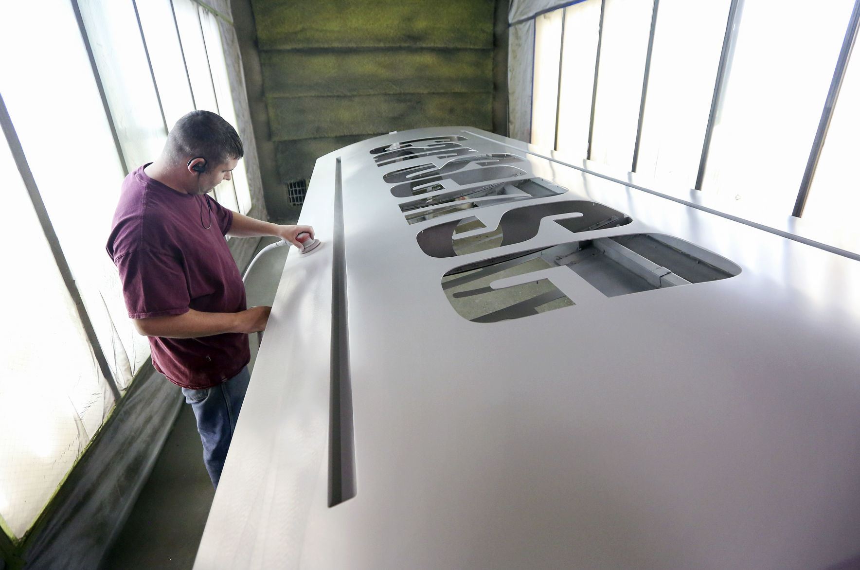Asher Klaas preps a sign for paint at Weitz Sign Company in Dubuque on Thursday, Aug. 22, 2019.    PHOTO CREDIT: NICKI KOHL