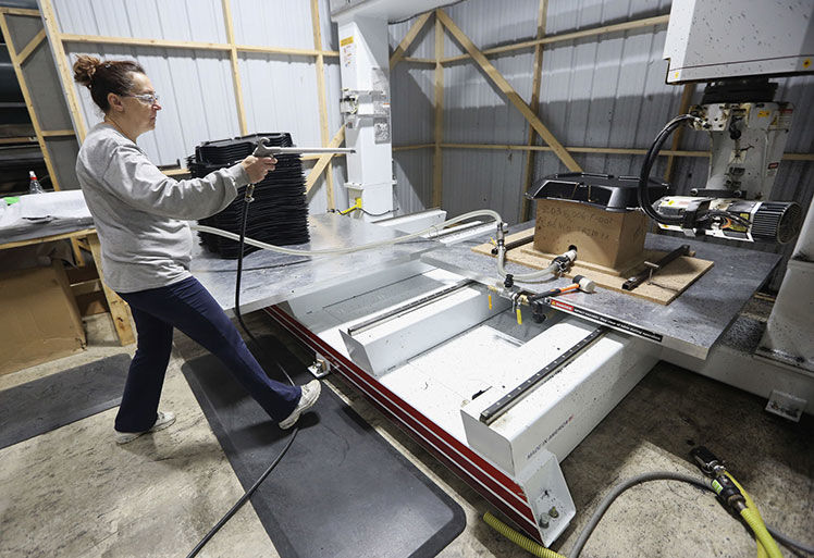 Nancy Yaddof operates a CNC to trim plastic at Plastics Unlimited in Preston, Iowa, on Thursday, Nov. 21, 2019.    PHOTO CREDIT: NICKI KOHL