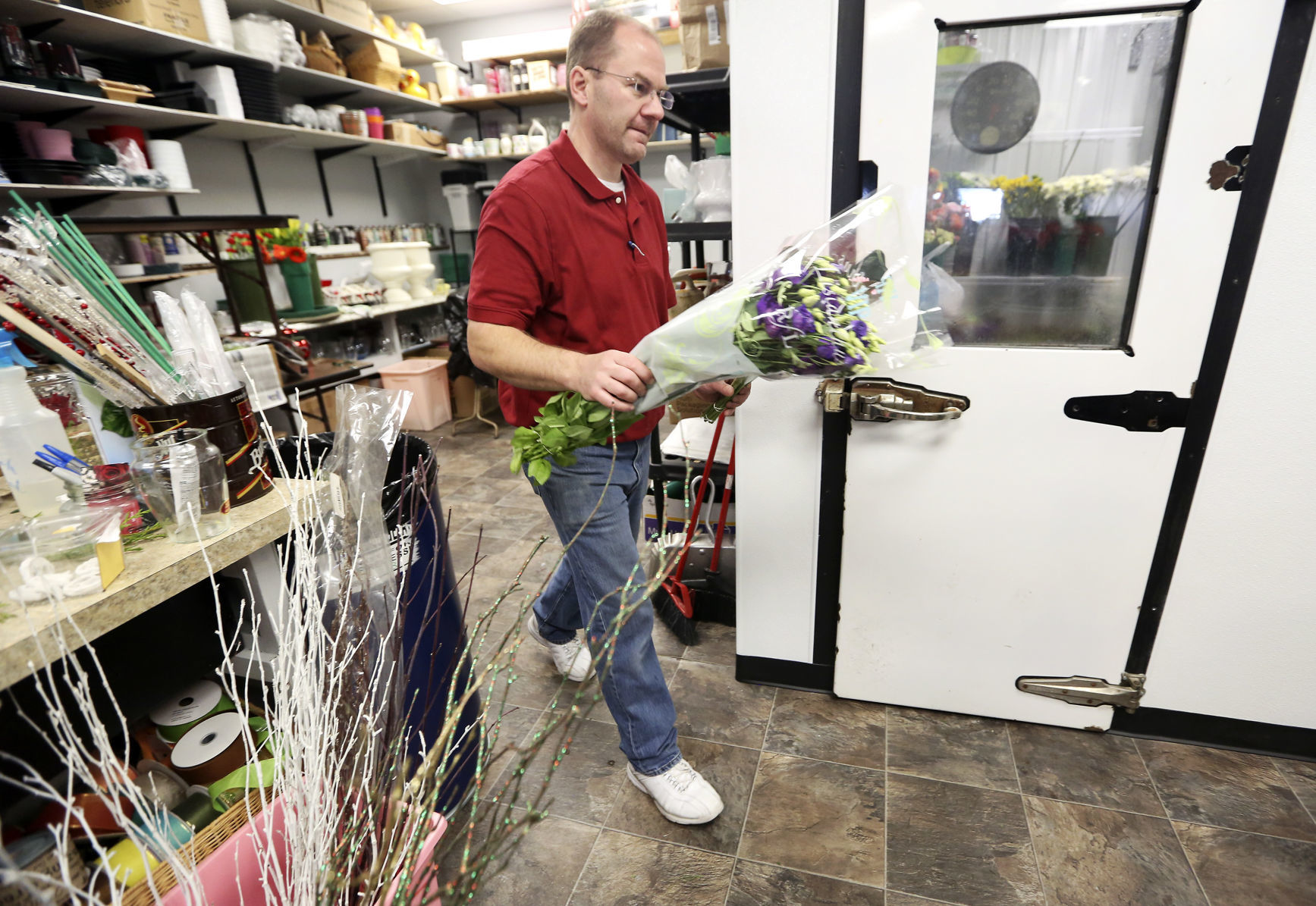 Owner Brian Fitting gathers flowers for arrangements at Butt