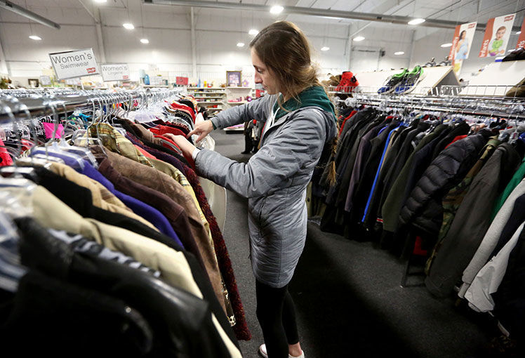 Shauna McAleer, of Dubuque, browses clothes at the business. PHOTO CREDIT: JESSICA REILLY