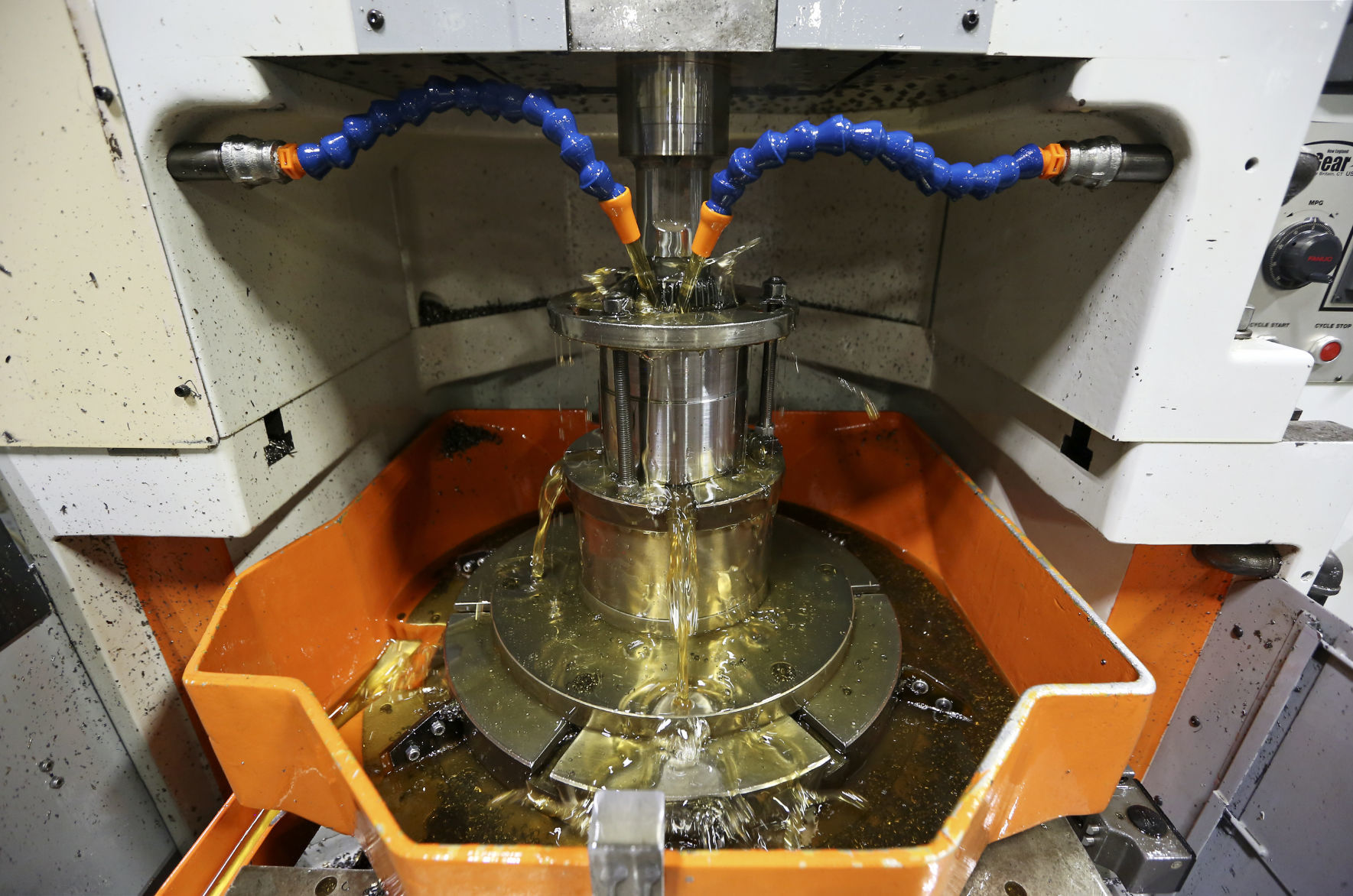 Oil cools an internal spline being shaped by a machine at The Adams Company in Dubuque.    PHOTO CREDIT: Nicki Kohl
Telegraph Herald