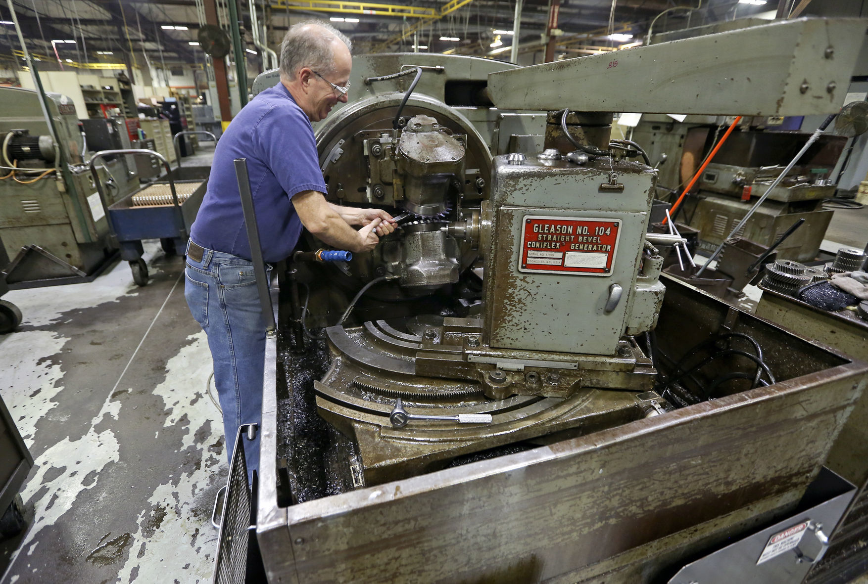 Ken Leik sets up a bevel gear cutting machine at The Adams Company in Dubuque.    PHOTO CREDIT: Nicki Kohl
Telegraph Herald