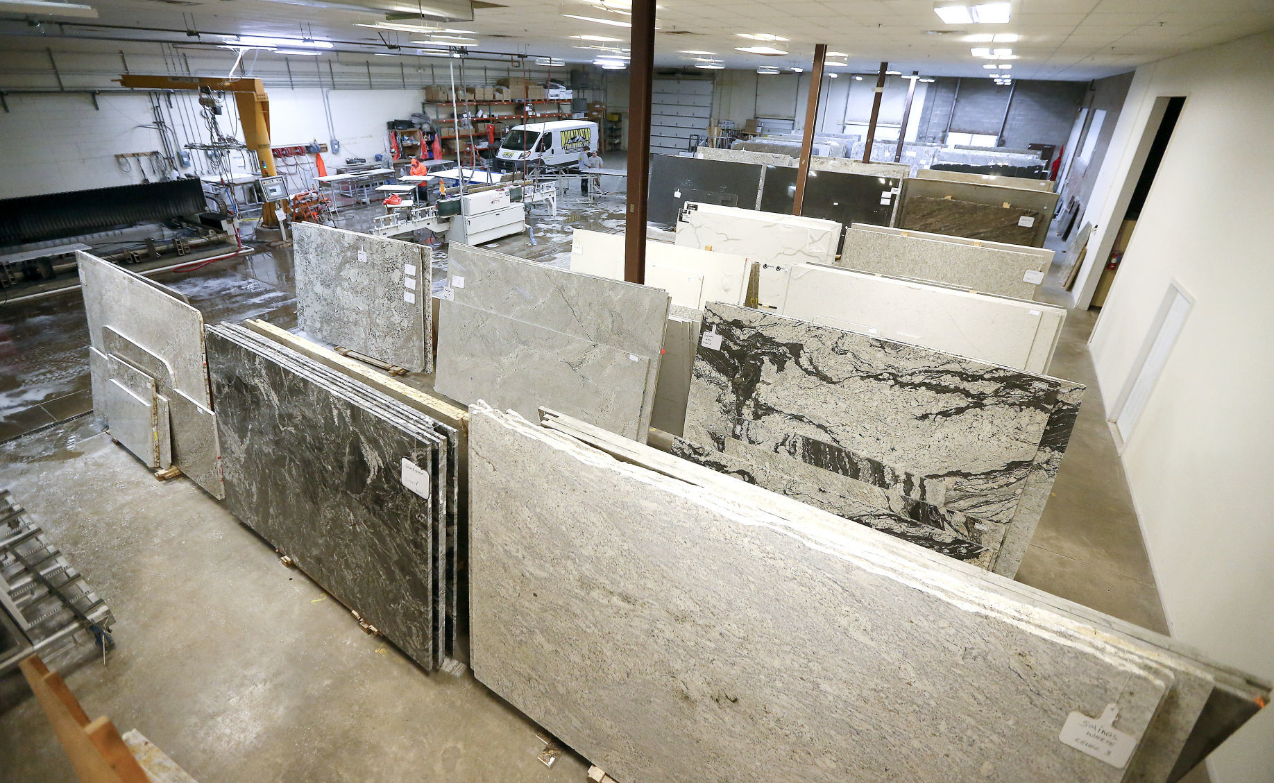 Huge pieces of granite wait to be cut at Mountaintop Stoneworks, Inc. in Dubuque.    PHOTO CREDIT: Dave Kettering