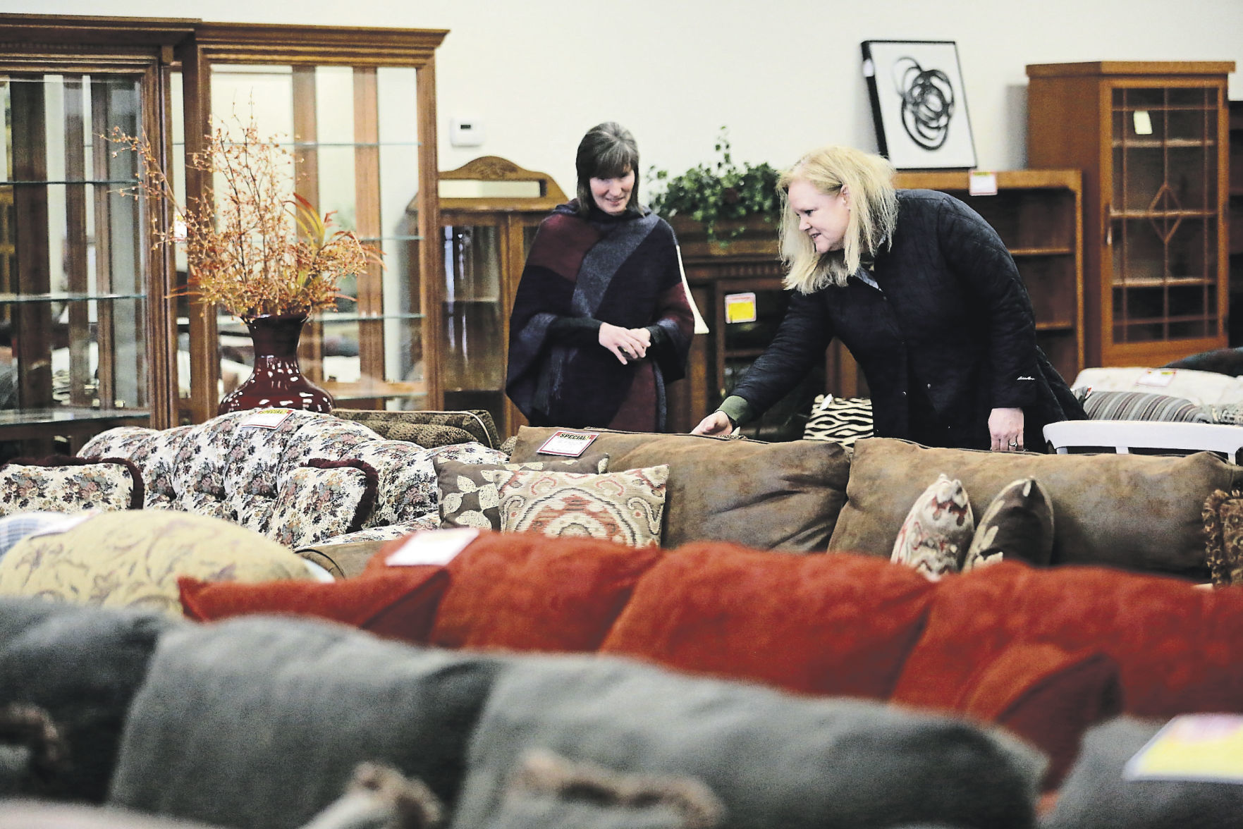 Lois Thurston (left) helps customer Sue Tefft at Affordable Furniture in Dubuque. PHOTO CREDIT: EILEEN MESLAR
