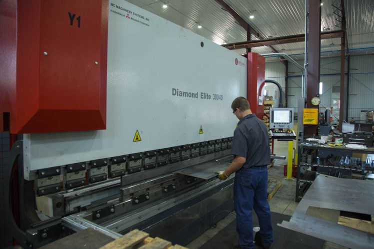 Andy Sprengelmeyer is operating a press brake at East Iowa Machine, Co., often known as EIMCo. The business started with two employees at a Dyersville, Iowa, location in 1992. Today, the facility is in Farley, Iowa, in a 130,000-square-foot building.    PHOTO CREDIT: EIMCo