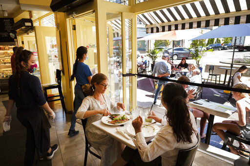 Liz Cahn, center, and her daughter Cara eat lunch at Meli-Melo Creperie, Juice Bar & Cafe, Wednesday, June 17, 2020 in Greenwich, Conn. The state began Phase 2 Wednesday, which includes allowing indoor seating at restaurants during the coronavirus pandemic. (AP Photo/Mark Lennihan) PHOTO CREDIT: Mark Lennihan