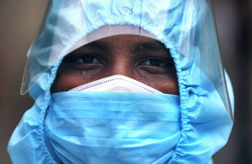 An Indian health worker wearing personal protective equipment looks on during a check up camp at a slum in Mumbai, India, Wednesday, June 17, 2020. India is the fourth hardest-hit country by the COVID-19 pandemic in the world after the U.S., Russia and Brazil. (AP Photo/Rafiq Maqbool) PHOTO CREDIT: Rafiq Maqbool