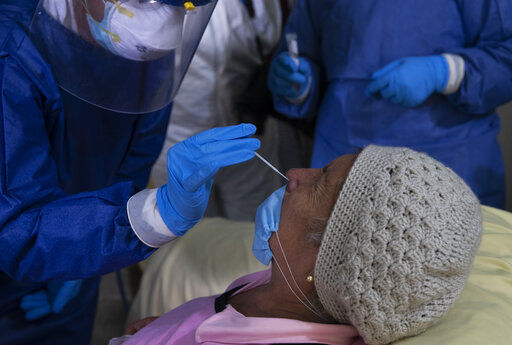 A health worker collects a nasal swab sample from 75-year-old Rebeca Jimenez to test for COVID-19, in Mexico City, Wednesday, June 17, 2020. (AP Photo/Marco Ugarte) PHOTO CREDIT: Marco Ugarte