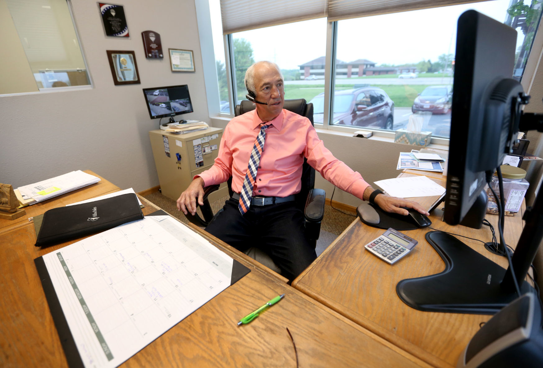 Greg Adams, owner and broker at ReMax Advantage Realty, works in his office in Dubuque. PHOTO CREDIT: Jessica Reilly