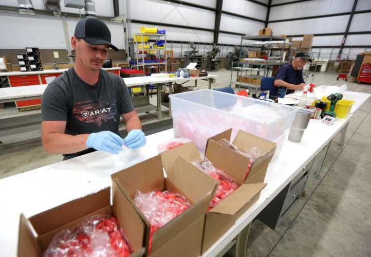 IBI Scientific employee Chris Schroeder works on packaging a product. PHOTO CREDIT: Dave Kettering