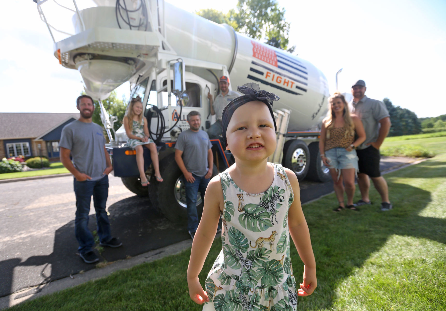 Ruby Ihm, 4, is seen with Matt Rutkowski (from left), Georgia Ihm, 9, Stefan Rutkowski, Dan Ihm, Chelsey Ihm and Steve Ihm in front of an Allied Redi-Mix & Stone truck in Lancaster, Wis., on Sunday. Allied Redi-Mix dedicated one of its trucks to Ruby, who is battling leukemia, and her uncle Dan drives it. PHOTO CREDIT: JESSICA REILLY