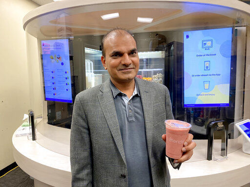Vipin Jain, CEO and cofounder of Blendid, holds a smoothie on Tuesday, June 30, 2020, in Sunnyvale, Calif., made by his company’s robotic kiosk that makes blended fruit drinks with no human intervention. “I expect in the next two years you will see pretty significant robotic adoption in the food space because of COVID,” said Jain. (AP Photo/Terry Chea) PHOTO CREDIT: Terry Chea