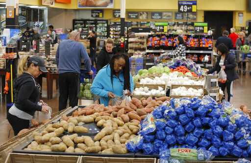 FILE - In this Nov. 27, 2019, file photo people shop for food the day before the Thanksgiving holiday at a Walmart Supercenter in Las Vegas. U.S. consumer prices increased slightly last month, driven higher by more expensive food. The Labor Department said Wednesday, March 11, 2020, that the consumer price index ticked up 0.1% last month, matching its January increase. (AP Photo/John Locher, File) PHOTO CREDIT: John Locher