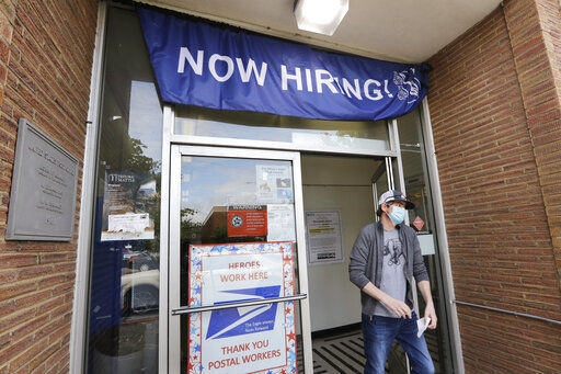 FILE - In this June 4, 2020, file photo, a customer walks out of a U.S. Post Office branch and under a banner advertising a job opening, in Seattle. Unemployment remains painfully high in the U.S. even as economic activity is slowly picking up. That reality will be on display Thursday, July 16, 2020, when the U.S. government releases data on the number of laid off workers seeking unemployment benefits the week prior and retail sales in June. (AP Photo/Elaine Thompson, File) PHOTO CREDIT: Elaine Thompson