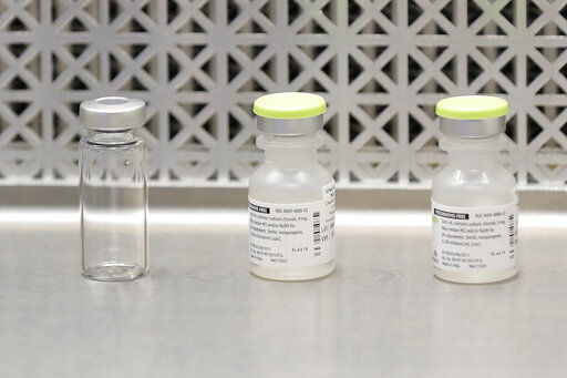 FILE - This March 16, 2020 file photo shows vials used by pharmacists to prepare syringes used on the first day of a first-stage safety study clinical trial of the potential vaccine for COVID-19, the disease caused by the new coronavirus, at the Kaiser Permanente Washington Health Research Institute in Seattle. The world