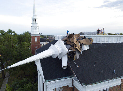 The steeple at College Church in Wheaton, Ill. was toppled during a storm Monday, Aug. 10, 2020, in the northwest suburbs of Chicago, Ill. Church officials check out the damage from the rooftop which also left several trees in the nearby park heavily damaged. (Mark Welsh /Daily Herald via AP) PHOTO CREDIT: Mark Welsh