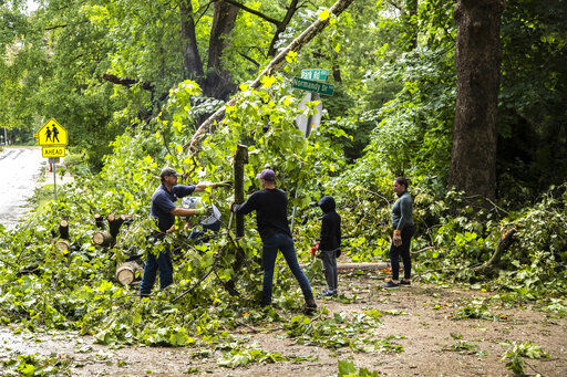 Residents help clear a fallen tree from an intersection after a severe storm, Monday, Aug. 10, 2020, in Iowa City, Iowa. (Joseph Cress/Iowa City Press-Citizen via AP) PHOTO CREDIT: Joseph Cress