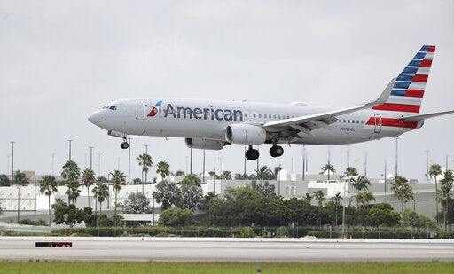 An American Airlines Boeing 737-823 lands at Miami International Airport, Monday, July 27, 2020, in Miami. American Airlines is dropping flights to 15 U.S. cities in October, when a federal requirement to serve those communities expires. American said Thursday, Aug. 20 that it will consider other changes unless the federal government provides more money to the embattled airline industry. (AP Photo/Wilfredo Lee) PHOTO CREDIT: Wilfredo Lee
