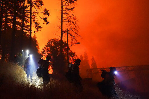 Members of the Laguna Hotshots, out of the Cleveland National Forest, walk down a hillside while fighting the Creek Fire, Sunday, Sept. 6, 2020, in Big Creek, Calif. (AP Photo/Marcio Jose Sanchez) PHOTO CREDIT: Marcio Jose Sanchez