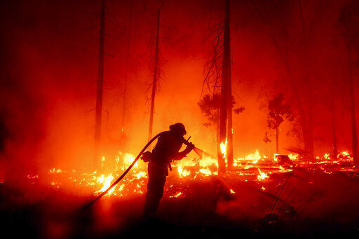 CORRECTS COUNTY TO MADERA COUNTY INSTEAD OF MARIPOSA COUNTY - A firefighter battles the Creek Fire as it threatens homes in the Cascadel Woods neighborhood of Madera County, Calif., on Monday, Sept. 7, 2020. (AP Photo/Noah Berger) PHOTO CREDIT: Noah Berger