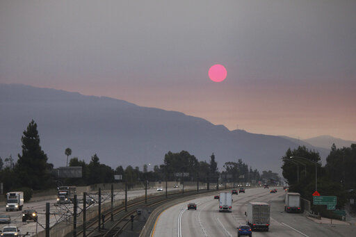 Smoke from wildfires burning east of Los Angeles dims the sunrise on Monday, Sept. 7, 2020, seen from Pasadena, Calif. The Bobcat Fire was burning near Cogswell Reservoir in the San Gabriel Mountains while the El Dorado Fire consumed thousands of acres of vegetation near the community of Yucaipa on the foothills of the San Bernardino Mountains. (AP Photo/John Antczak) PHOTO CREDIT: John Antczak
