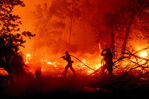 CORRECTS COUNTY TO MADERA COUNTY INSTEAD OF MARIPOSA COUNTY - Firefighters battle the Creek Fire as it threatens homes in the Cascadel Woods neighborhood of Madera County, Calif., on Monday, Sept. 7, 2020. (AP Photo/Noah Berger) PHOTO CREDIT: Noah Berger