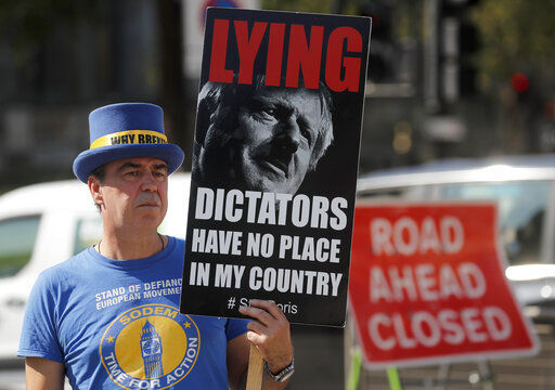 A pro EU protester stands near Parliament in London, Monday, Sept. 14, 2020. Boris Johnson is facing the possibility of a Tory rebellion and major damage to his chances of a trade deal with the EU unless he removes controversial parts of the internal Bill which is in the House of Commons for its second reading Monday.(AP Photo/Frank Augstein) PHOTO CREDIT: Frank Augstein