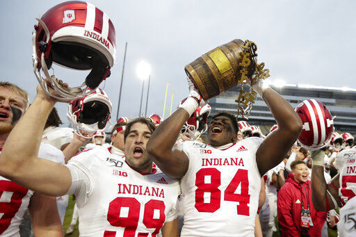 FILE - In this Nov. 30, 2019, file photo, Indiana tight end Turon Ivy Jr. (84) and place kicker Nathanael Snyder (99) celebrate with the Old Oaken Bucket following an NCAA college football game against Purdue in West Lafayette, Ind. Big Ten is going to give fall football a shot after all. Less than five weeks after pushing football and other fall sports to spring in the name of player safety during the pandemic, the conference changed course Wednesday, Sept. 16, 2020, and said it plans to begin its season the weekend of Oct. 23-24. (AP Photo/Michael Conroy, File) PHOTO CREDIT: Michael Conroy