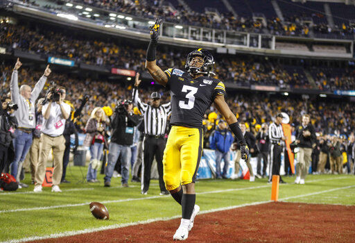 FILE - In this Dec. 27, 2019, file photo, Iowa freshman running back Tyrone Tracy Jr., runs the ball for a touchdown against USC in the first quarter during the Holiday Bowl NCAA college football game in San Diego. Big Ten is going to give fall football a shot after all. Less than five weeks after pushing football and other fall sports to spring in the name of player safety during the pandemic, the conference changed course Wednesday, Sept. 16, 2020, and said it plans to begin its season the weekend of Oct. 23-24. (Bryon Houlgrave/The Des Moines Register via AP, File) PHOTO CREDIT: Bryon Houlgrave/The Register