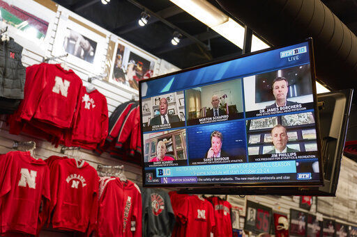 The Husker Hounds sports apparel store in Omaha, Neb., shows on television screens Wednesday, Sept. 16, 2020, a Big Ten virtual news conference to discuss the reopening of the football season. Less than five weeks after pushing football and other fall sports to spring in the name of player safety during the pandemic, the conference changed course Wednesday and said it plans to begin its season the Oct. 23-24 weekend. Each team will have an eight-game schedule. (AP Photo/Nati Harnik) PHOTO CREDIT: Nati Harnik