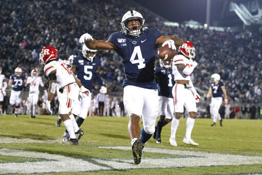 FILE - In this Nov. 30, 2019, file photo, Penn State running back Journey Brown (4) celebrates his third quarter touchdown run against Rutgers during an NCAA college football game in State College, Pa. Big Ten is going to give fall football a shot after all. Less than five weeks after pushing football and other fall sports to spring in the name of player safety during the pandemic, the conference changed course Wednesday, Sept. 16, 2020, and said it plans to begin its season the weekend of Oct. 23-24. (AP Photo/Barry Reeger, File) PHOTO CREDIT: Barry Reeger