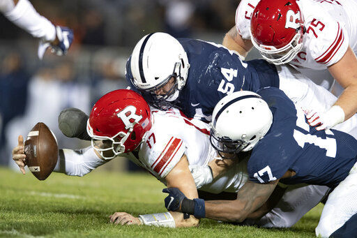 FILE - In this Nov. 30, 2019, file photo, Penn State defenders Robert Windsor (54) and Jayson Oweh (28) cause Rutgers quarterback Johnny Langan (17) to fumble in the third quarter of an NCAA college football game in State College, Pa. Big Ten is going to give fall football a shot after all. Less than five weeks after pushing football and other fall sports to spring in the name of player safety during the pandemic, the conference changed course Wednesday, Sept. 16, 2020, and said it plans to begin its season the weekend of Oct. 23-24. (AP Photo/Barry Reeger, File) PHOTO CREDIT: Barry Reeger