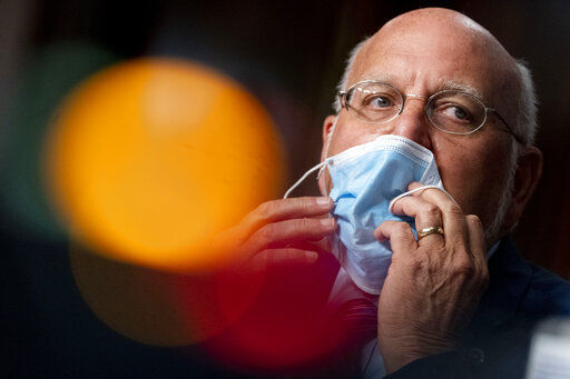 Centers for Disease Control and Prevention Director Dr. Robert Redfield puts his mask back on after speaking at a Senate Appropriations subcommittee hearing on a "Review of Coronavirus Response Efforts" on Capitol Hill, Wednesday, Sept. 16, 2020, in Washington. (AP Photo/Andrew Harnik, Pool) PHOTO CREDIT: Andrew Harnik