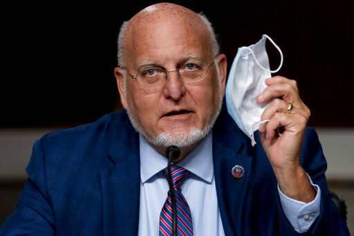 Centers for Disease Control and Prevention Director Dr. Robert Redfield holds up his mask as he speaks at a Senate Appropriations subcommittee hearing on a "Review of Coronavirus Response Efforts" on Capitol Hill, Wednesday, Sept. 16, 2020, in Washington. (AP Photo/Andrew Harnik, Pool) PHOTO CREDIT: Andrew Harnik